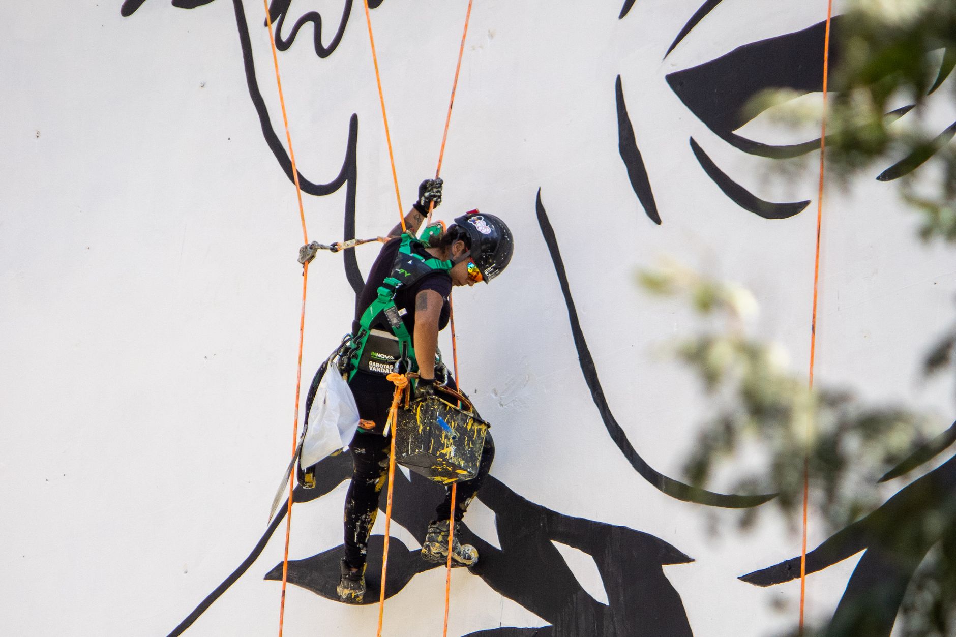 A person painting a wall with a roller