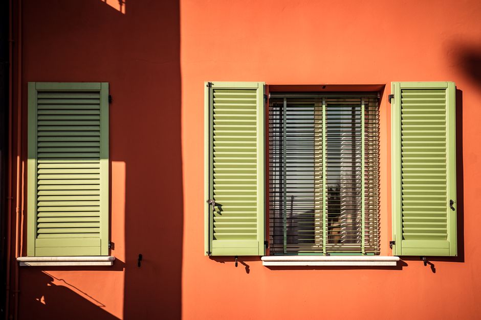Painted house exterior with trim and a door in daylight