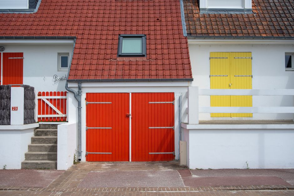 House exterior with a painted wall and a freshly coloured door