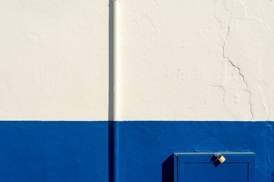 House exterior with a painted wall and a freshly coloured door